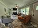 Cozy living room showcases a fireplace, ceiling fan, and comfortable seating for relaxation and entertainment at 3546 Kershaw Camden Hwy, Lancaster, SC 29720
