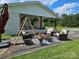 Inviting outdoor patio with comfortable seating, decorative plants, and a charming swing at 3546 Kershaw Camden Hwy, Lancaster, SC 29720