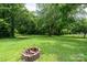 Lush green backyard featuring mature trees, perfect for outdoor activities and relaxation at 357 N Main St, Mount Pleasant, NC 28124