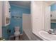 Cozy bathroom with blue walls, a combined tub and shower, and vanity with a sink and mirror at 357 N Main St, Mount Pleasant, NC 28124