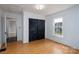 Empty bedroom with wooden floors, a window providing natural light, and a closet with sliding doors at 357 N Main St, Mount Pleasant, NC 28124