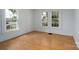 Bright bedroom featuring hardwood floors and large windows, offering a serene and airy atmosphere at 357 N Main St, Mount Pleasant, NC 28124