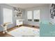 Virtually staged ' bedroom with hardwood floors, two windows, and playful decor at 357 N Main St, Mount Pleasant, NC 28124