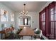 The dining room is virtually staged with modern decor, a wood table and a console table at 357 N Main St, Mount Pleasant, NC 28124