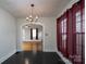 This dining room features a chandelier, and flows into the living room at 357 N Main St, Mount Pleasant, NC 28124