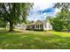 Charming home with a detached garage and a well-maintained lawn, showcasing curb appeal at 357 N Main St, Mount Pleasant, NC 28124