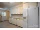 The kitchen features white cabinets and countertops, and exterior access at 357 N Main St, Mount Pleasant, NC 28124
