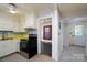 The kitchen flows into the dining room and features white cabinets at 357 N Main St, Mount Pleasant, NC 28124