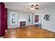 Spacious living room with hardwood floors, a decorative fireplace, and windows with natural light at 357 N Main St, Mount Pleasant, NC 28124