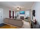 Virtually staged living room with hardwood floors, fireplace, comfortable seating, and plenty of natural light at 357 N Main St, Mount Pleasant, NC 28124