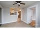 Living room with ceiling fan and doorway to kitchen with view of appliances at 357 N Main St, Mount Pleasant, NC 28124