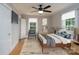 Virtually staged main bedroom with refinished floors and abundant natural light at 357 N Main St, Mount Pleasant, NC 28124