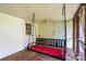 This porch features an outdoor swing, a ceiling fan and access to the exterior at 357 N Main St, Mount Pleasant, NC 28124