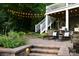 Inviting backyard with string lights, deck with stairs, and comfortable outdoor seating at 369 Skyland Ct, Mount Gilead, NC 27306
