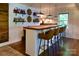 Custom bar area with wooden countertop, stocked shelves, seating, and pendant lighting at 369 Skyland Ct, Mount Gilead, NC 27306