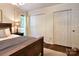 Bright bedroom featuring a wood frame bed, hardwood floors, and large closets for ample storage at 369 Skyland Ct, Mount Gilead, NC 27306