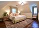 Charming bedroom featuring a large bed, neutral tones, sloped ceiling, and a decorative area rug at 369 Skyland Ct, Mount Gilead, NC 27306
