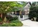 Beautifully landscaped exterior with a charming porch, walkway, and mature trees at 369 Skyland Ct, Mount Gilead, NC 27306