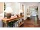 Inviting entryway showcasing hardwood floors, stylish console table, and elegant decor at 369 Skyland Ct, Mount Gilead, NC 27306