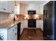 Charming kitchen featuring granite counters, stainless steel appliances, and wood flooring at 369 Skyland Ct, Mount Gilead, NC 27306