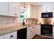 Charming kitchen featuring granite counters, stainless steel appliances, and wood flooring at 369 Skyland Ct, Mount Gilead, NC 27306