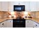 Bright kitchen featuring granite counters, stainless steel appliances, and stone backsplash at 369 Skyland Ct, Mount Gilead, NC 27306