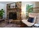 Cozy living room featuring a stone fireplace, stylish seating, and natural light at 369 Skyland Ct, Mount Gilead, NC 27306