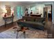 Spacious living room with a cozy couch, stylish decor, and a view of the game room beyond at 369 Skyland Ct, Mount Gilead, NC 27306