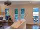 Bright living room with french doors leading to a deck, lake views, and a comfortable seating area at 369 Skyland Ct, Mount Gilead, NC 27306