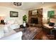 Comfortable living room featuring a stone fireplace, stylish seating, and wood flooring at 369 Skyland Ct, Mount Gilead, NC 27306