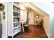 Cozy home office with built-in bookshelves, hardwood floors, and a desk with a comfortable chair at 369 Skyland Ct, Mount Gilead, NC 27306