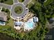 Aerial view of a community pool and playground area with a pond nearby at 398 Hampton Trail Dr # 97, Fort Mill, SC 29708