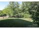 A serene backyard featuring a well-maintained lawn, framed by trees and foliage at 398 Hampton Trail Dr # 97, Fort Mill, SC 29708