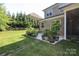 Expansive backyard featuring a lush lawn and a variety of potted plants around the patio at 398 Hampton Trail Dr # 97, Fort Mill, SC 29708
