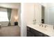 The primary bathroom features a dark vanity, bright lighting, and a decorative mirror at 398 Hampton Trail Dr # 97, Fort Mill, SC 29708