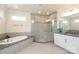 Elegant bathroom featuring a soaking tub, glass-enclosed shower, and stylish vanity at 398 Hampton Trail Dr # 97, Fort Mill, SC 29708