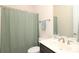 Bathroom features a shower with a green shower curtain, ample lighting, and a decorative mirror at 398 Hampton Trail Dr # 97, Fort Mill, SC 29708