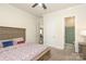 Comfortable bedroom features neutral walls and carpet, ensuite bathroom, and sunny windows at 398 Hampton Trail Dr # 97, Fort Mill, SC 29708