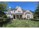 Inviting two-story home featuring a manicured lawn, brick accents, and a covered front porch with columns at 398 Hampton Trail Dr # 97, Fort Mill, SC 29708
