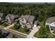 An exterior view showcases a well-maintained two-story home with a lush lawn, driveway, and a basketball court at 398 Hampton Trail Dr # 97, Fort Mill, SC 29708