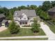 Beautiful two-story home featuring manicured lawn, brick accents, and a basketball court and driveway at 398 Hampton Trail Dr # 97, Fort Mill, SC 29708