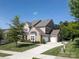 Spacious home with a three-car garage, long driveway, manicured lawn, and mature trees at 398 Hampton Trail Dr # 97, Fort Mill, SC 29708