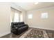 Comfortable living room featuring a leather sofa, hardwood floors, and natural light from the windows at 398 Hampton Trail Dr # 97, Fort Mill, SC 29708