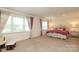 Elegant main bedroom with plush carpeting, large windows, and stylish furniture at 398 Hampton Trail Dr # 97, Fort Mill, SC 29708