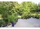 An inviting outdoor patio with assorted plants and a peaceful backyard view at 398 Hampton Trail Dr # 97, Fort Mill, SC 29708