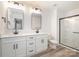 Bathroom featuring dual sinks, modern lighting, a glass-enclosed shower, and hardwood style floors at 4021 Jenison Valley Ct, Charlotte, NC 28214