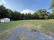 Expansive backyard featuring a large shed and ample green space, perfect for outdoor activities at 40287 Palmerville Rd, New London, NC 28127