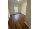 Cozy bedroom featuring a window for natural light and wood-look flooring for a modern touch at 40287 Palmerville Rd, New London, NC 28127