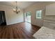 Cozy dining area featuring hardwood floors, modern chandelier, and sliding door to outdoor deck with white trim at 40287 Palmerville Rd, New London, NC 28127