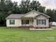 Charming single-story home with a well-maintained lawn, inviting front porch, and lovely curb appeal at 40287 Palmerville Rd, New London, NC 28127
